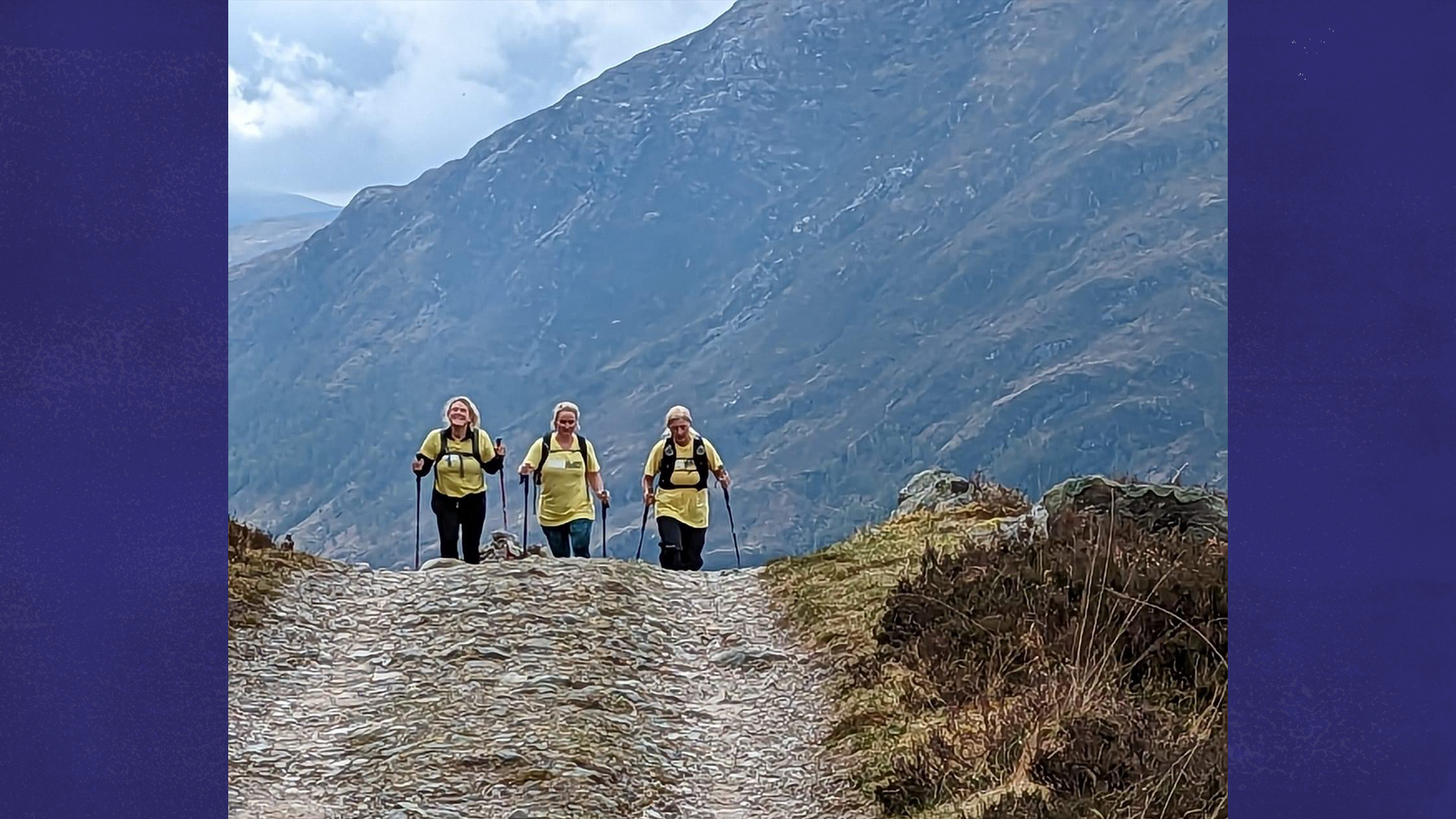 Three members of 4 Families Walking hiking up a hill.