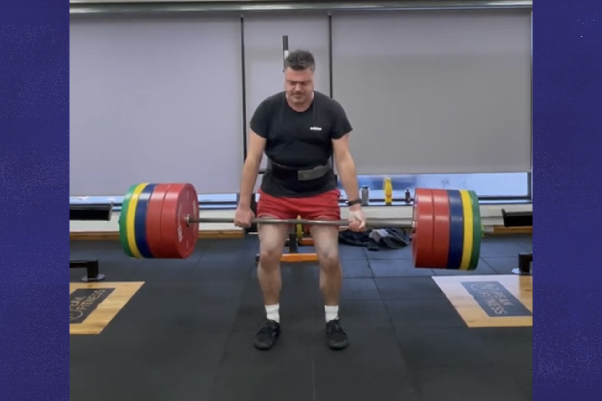 Craig lifting a heavyweight at the gym.
