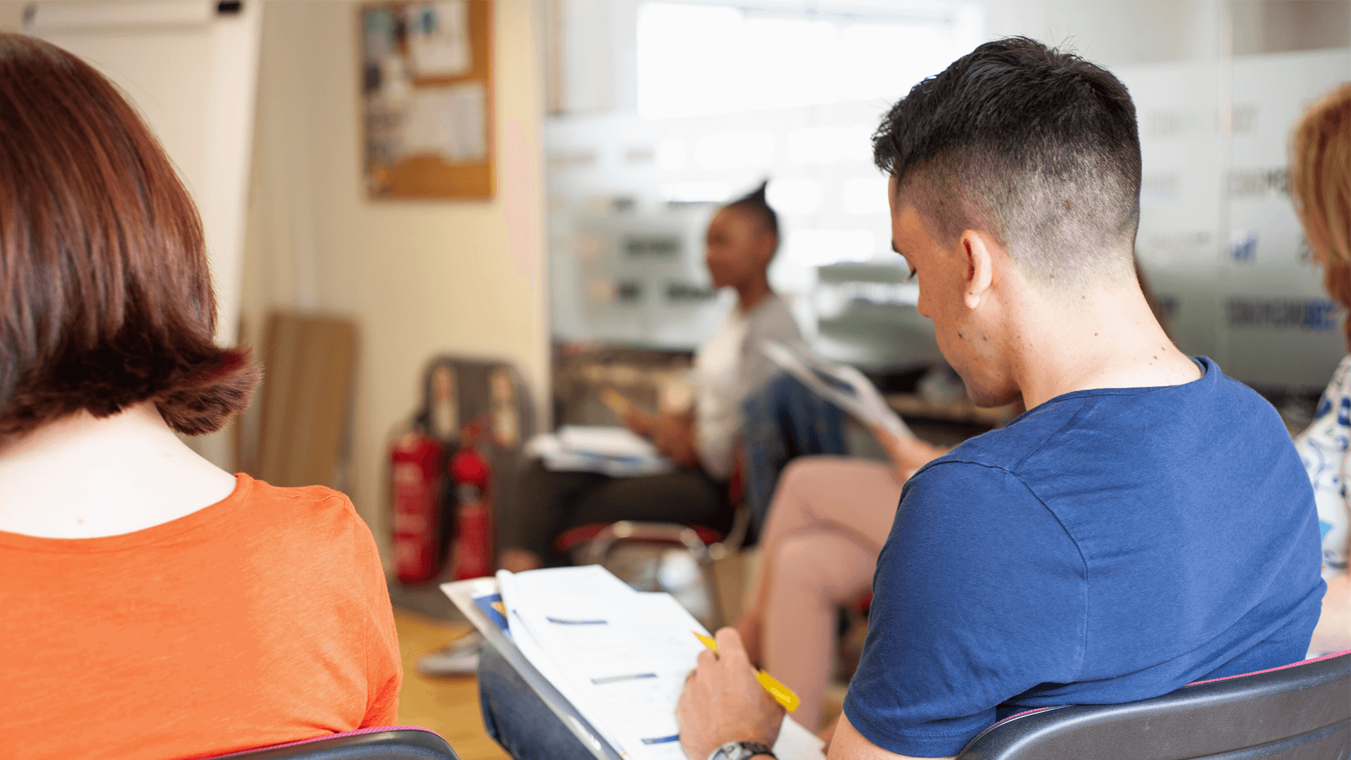 back shot of a group of parents answering a worksheet during a parent group activity